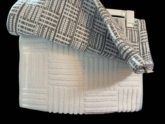 Textured white and gray bath towel set featuring a modern design.