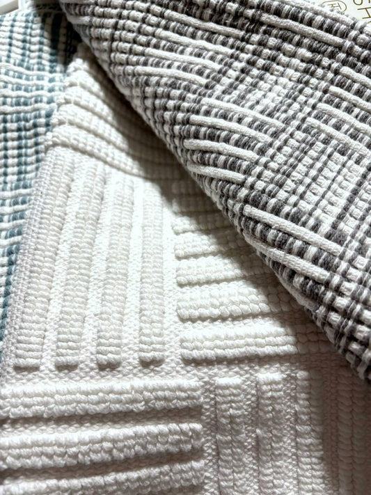 Textured white and gray cotton fabric with a grid pattern for home decor.