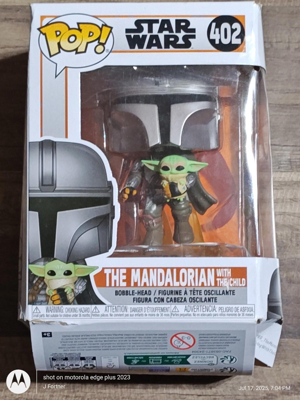 The Mandalorian with The Child Funko Pop figure in box, featuring detailed design and vibrant colors.