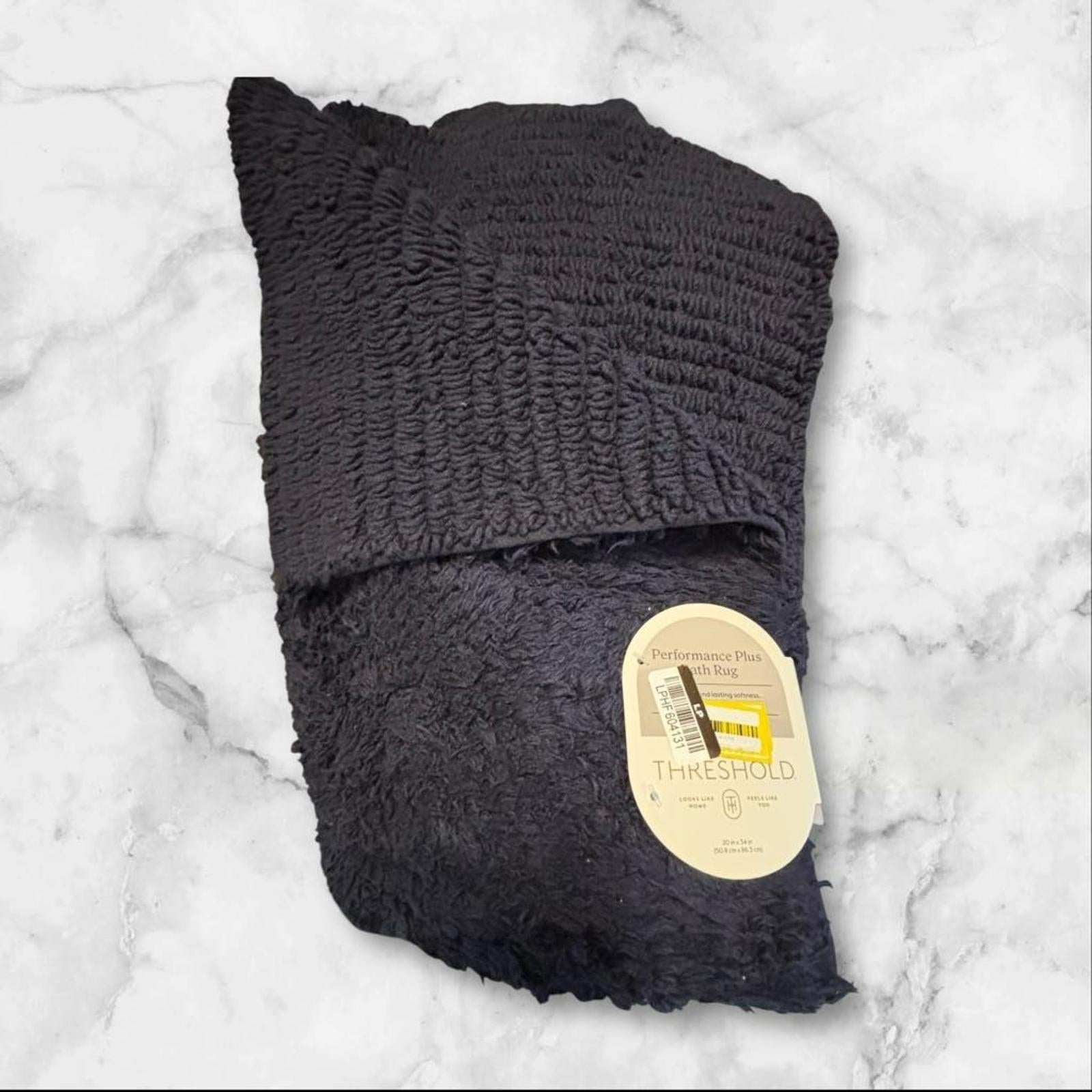 The Shield blanket in dark gray color, soft and cozy fabric, perfect for warmth.