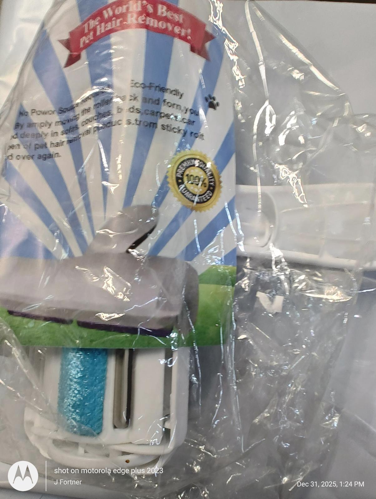 The World's Best Lint Roller features a blue adhesive roller for effective lint removal.