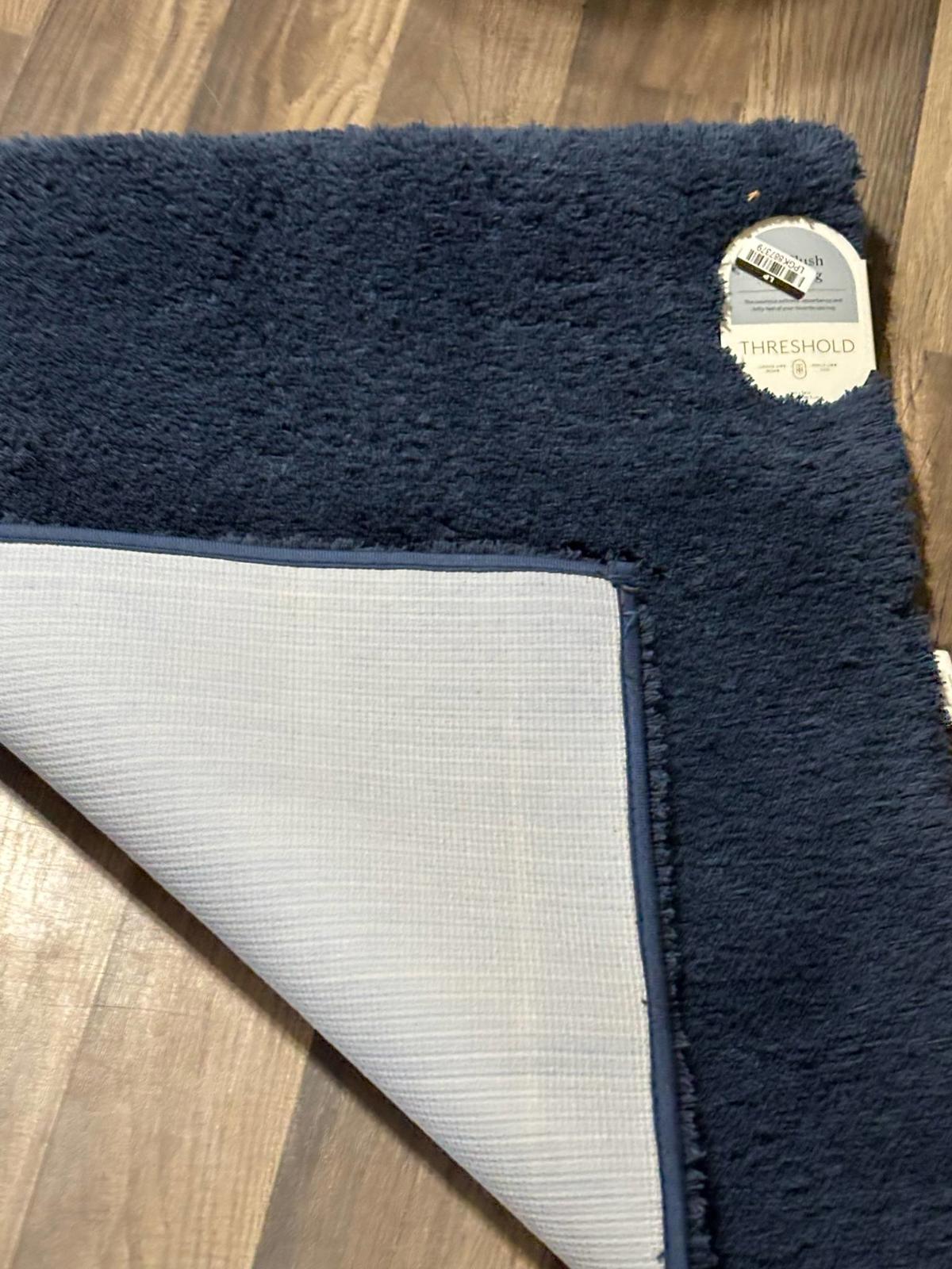 Threshold navy blue plush area rug with a soft texture and non-slip backing.