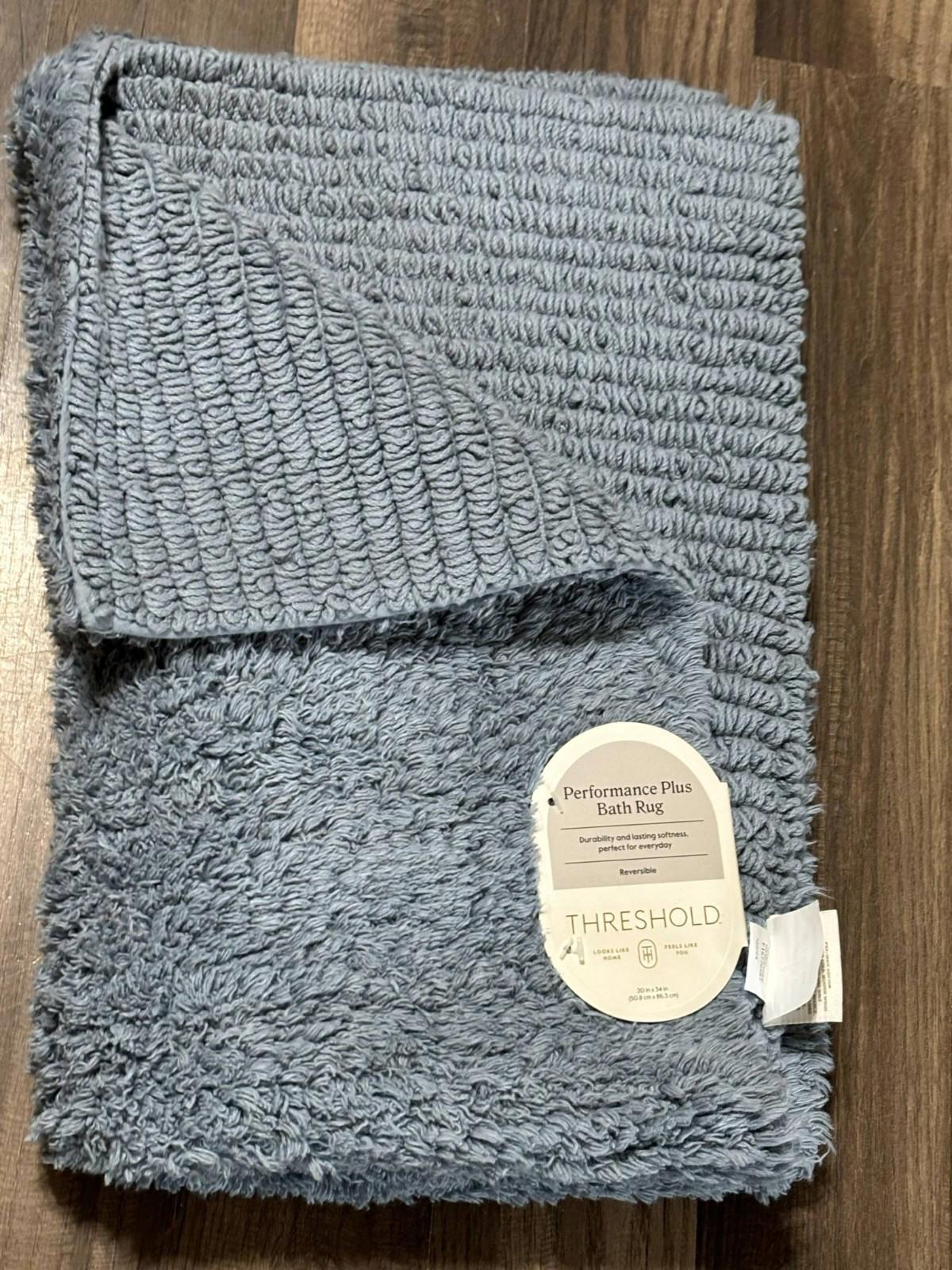Threshold plush bath rug in soft blue color, featuring a textured surface and cozy feel.