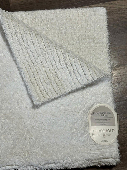 Threshold plush bath rug featuring a soft, fluffy texture and a stylish design.