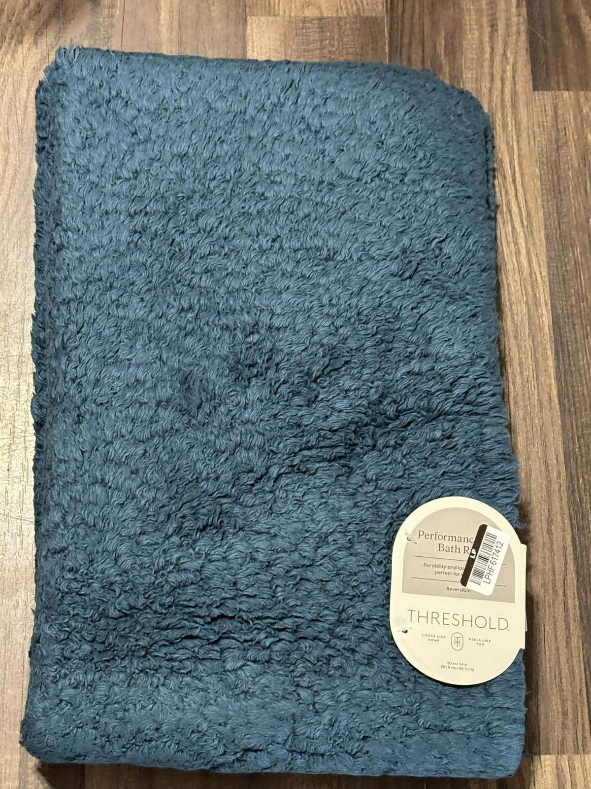Threshold plush bath mat in soft blue color, perfect for adding comfort to your bathroom.