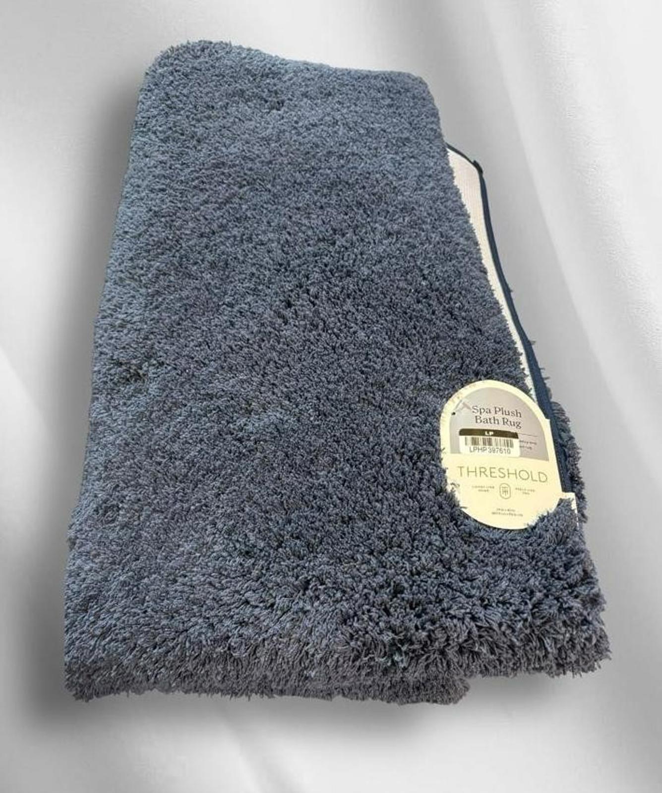 Threshold plush throw blanket in soft blue color, perfect for cozying up.