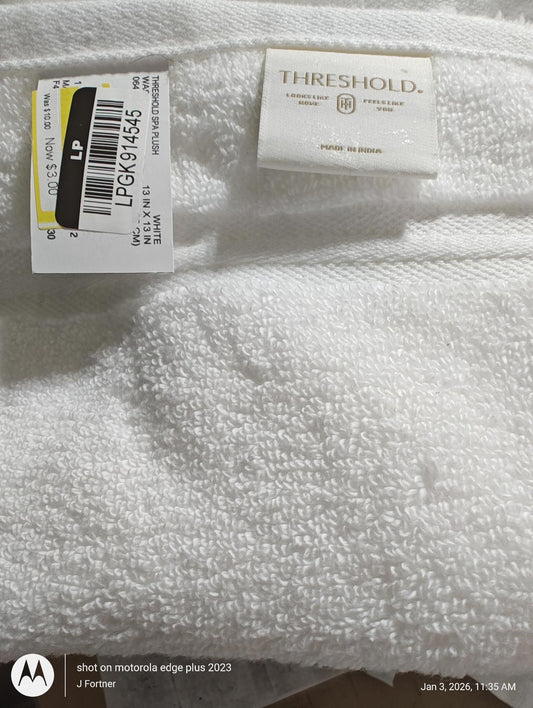 Threshold white bath towel with soft texture and label attached.