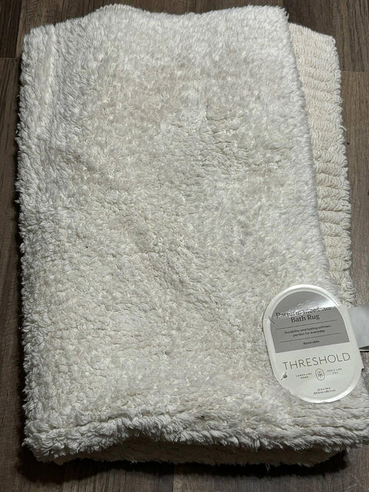 Threshold white plush bath towel with soft texture and tag visible.