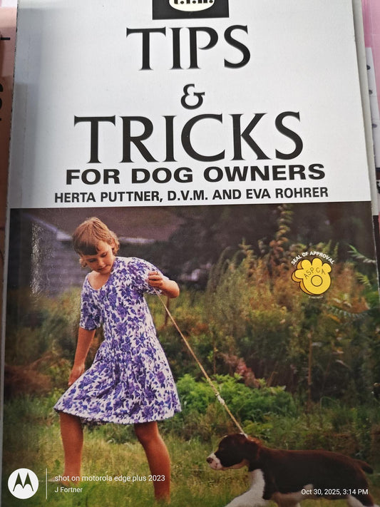 Tips and Tricks for Dog Owners book cover featuring a girl in a purple dress walking a dog.