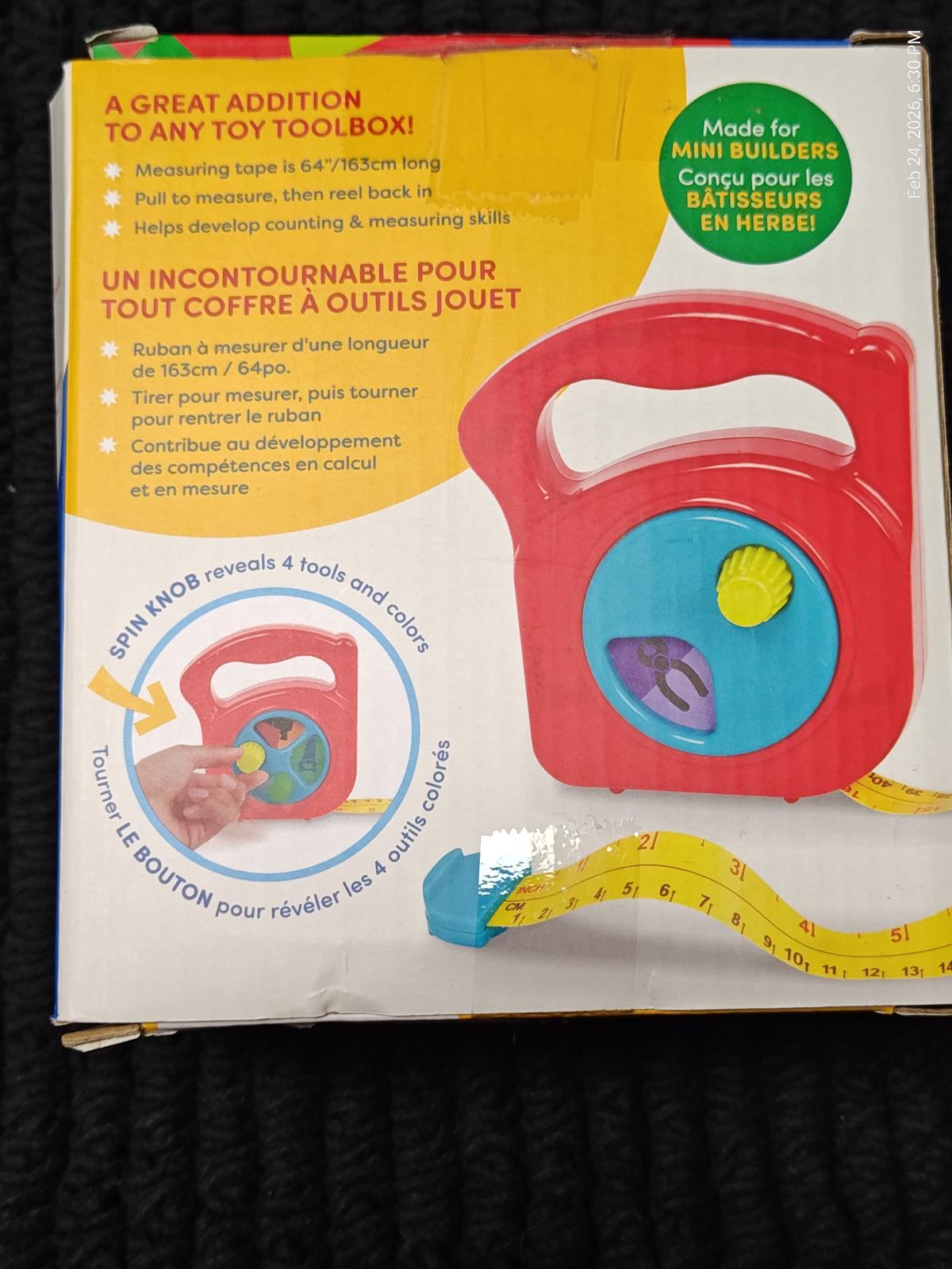 Toy Toolbox with colorful design, featuring tools and a measuring tape for mini builders.