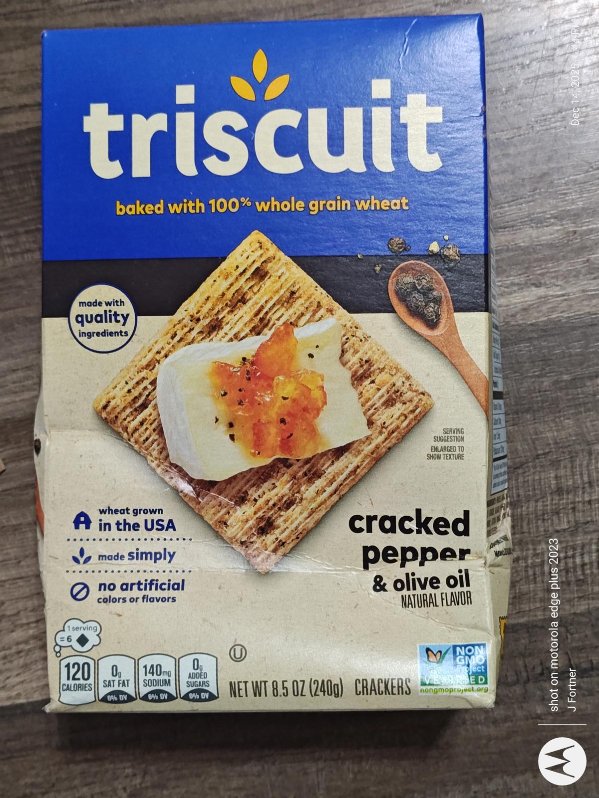 Triscuit cracked pepper and olive oil crackers with a topping of cream cheese and jam.