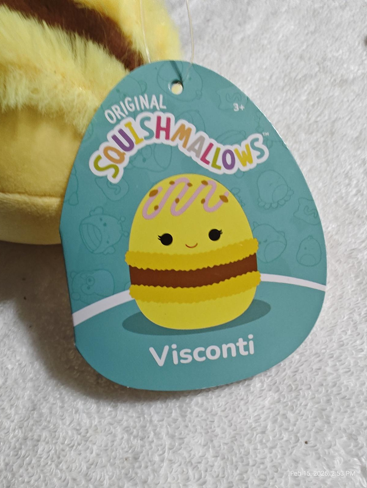 Visconti Squishmallow featuring a cute yellow egg design with chocolate stripes.