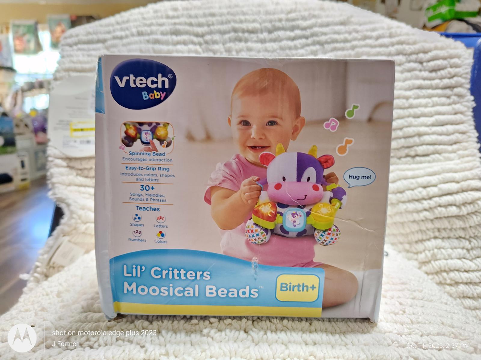 VTech Lil' Critters Moosical Beads toy box featuring a smiling baby holding colorful beads.