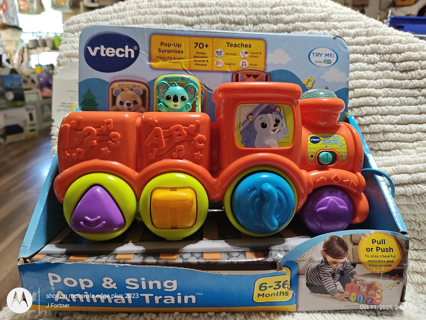 VTech Pop and Sing Animal Train toy with colorful buttons and animal characters.