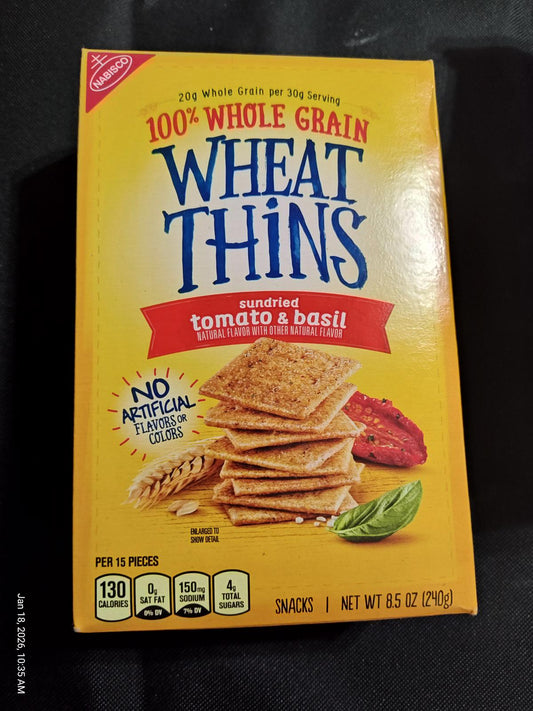 Wheat Thins sundried tomato and basil flavor, 100% whole grain crackers in a yellow box.