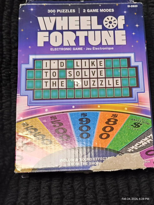 Wheel of Fortune electronic game box featuring colorful puzzle board and game modes.