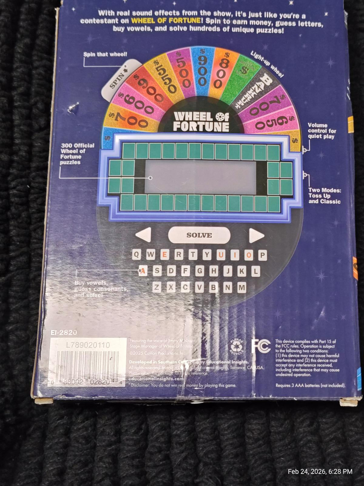 Wheel of Fortune game console featuring colorful display and buttons for gameplay.