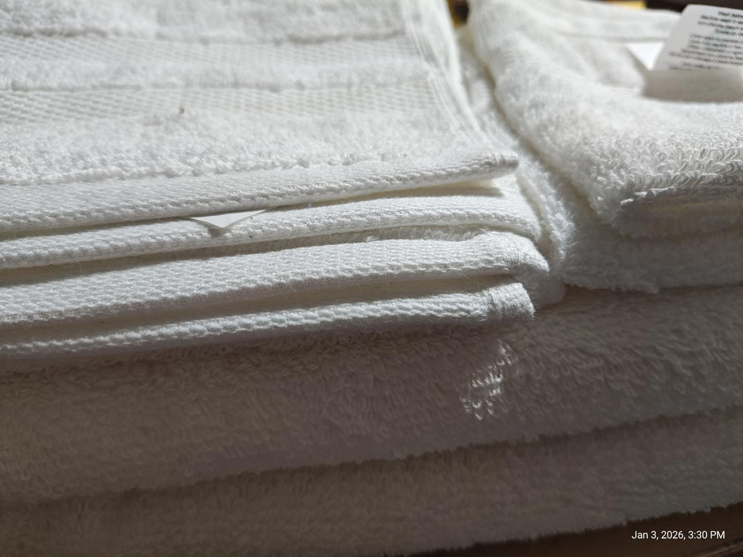 White Bath Towels stacked neatly, showcasing soft texture and absorbent quality.