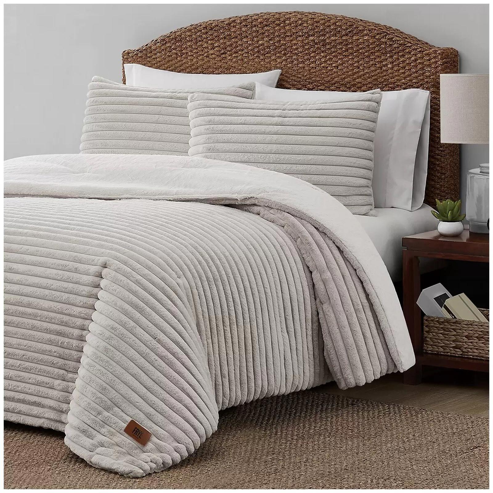 Cozy White Striped Comforter Set with matching pillows on a bed.