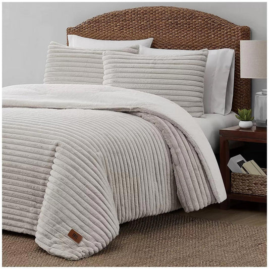 Cozy White Striped Comforter Set with matching pillows on a bed.