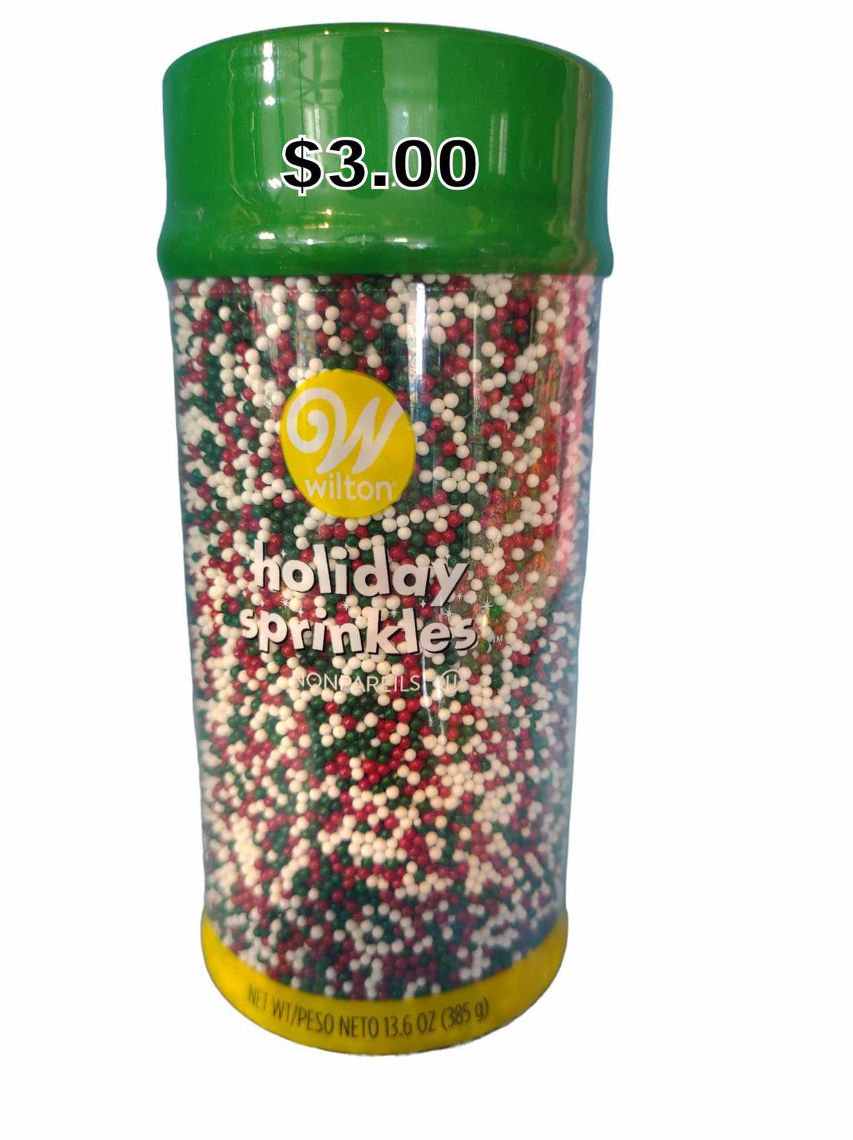 Wilton Holiday Sprinkles in a green container, featuring red, white, and green colors for festive baking.