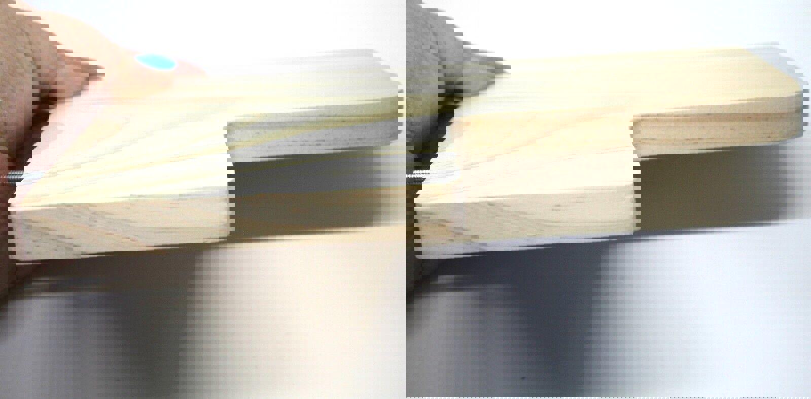 Wooden cutting board with a unique handle design, ideal for kitchen use.