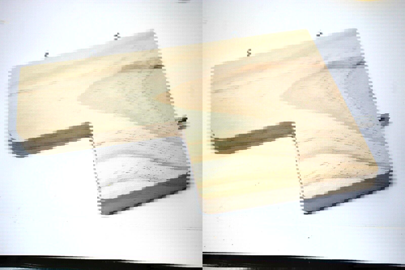 Wooden cutting board with a unique shape and smooth finish.