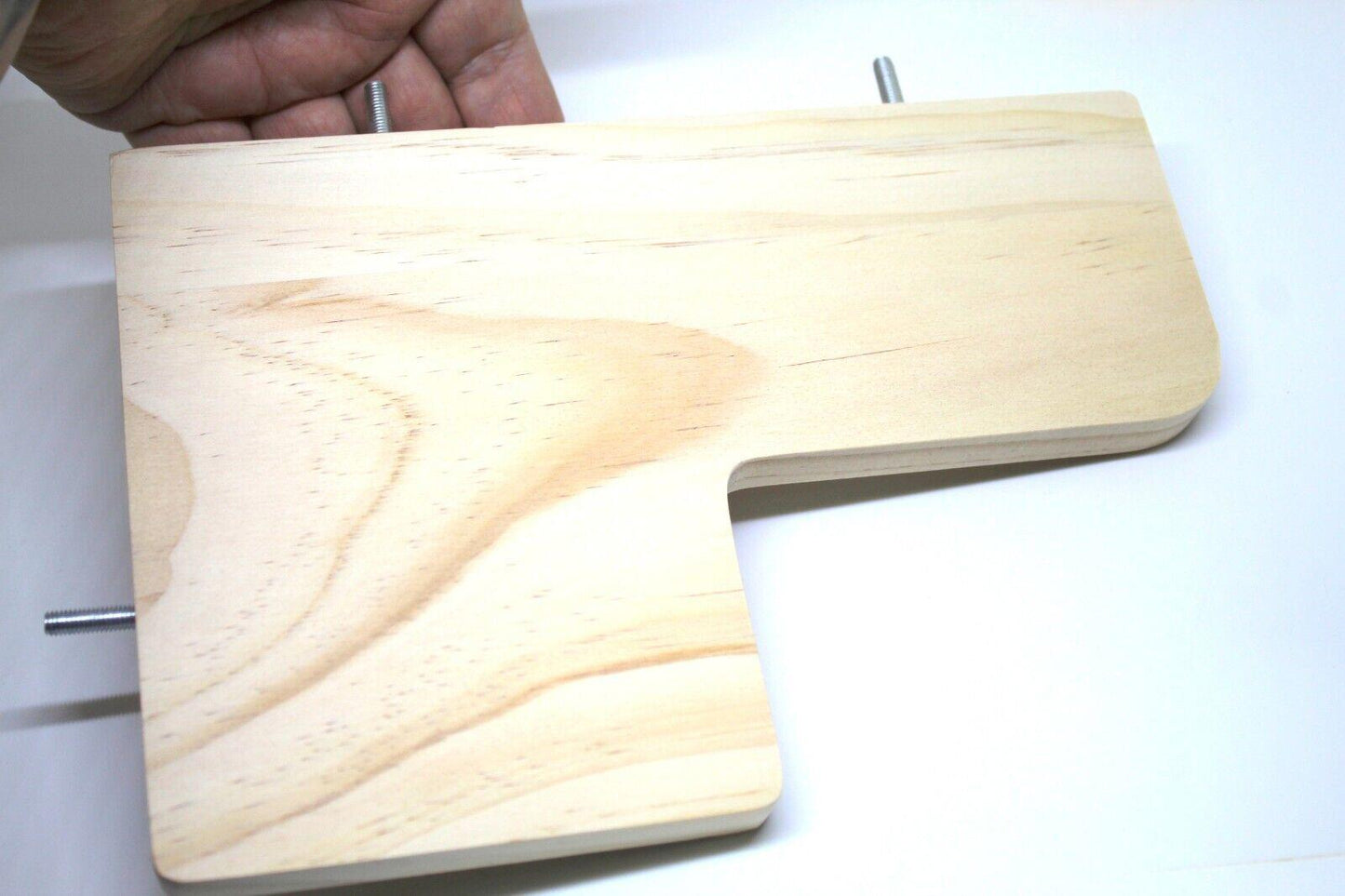 Wooden L-shaped cutting board with smooth surface and natural grain.