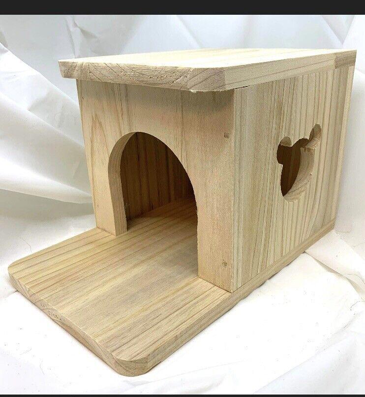 Wooden Dog House with Mickey Mouse Cutout, perfect for pets to relax in.