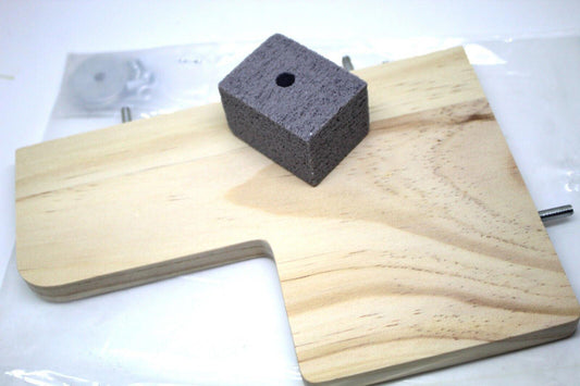 Woodworking clamp base with a gray foam block for stability.