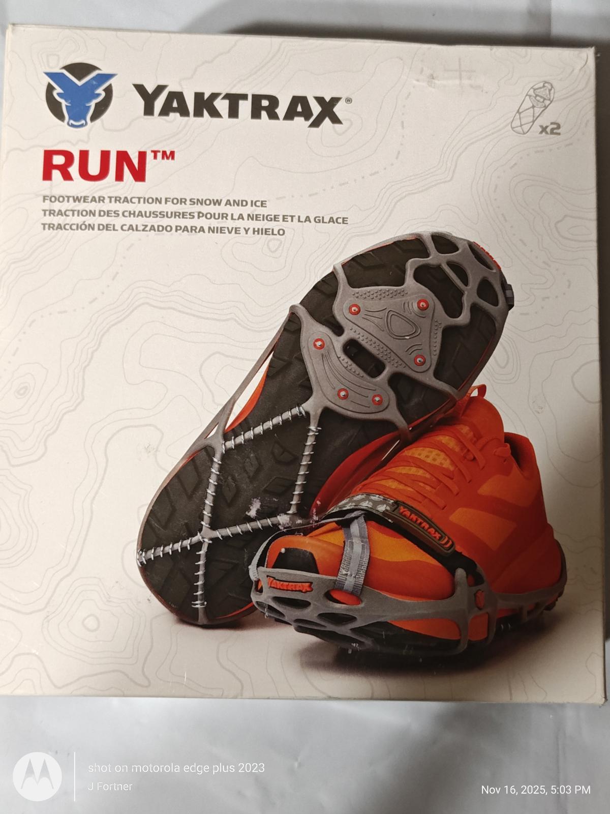 Yaktrax Run traction device for snow and ice, featuring a durable design and orange color.