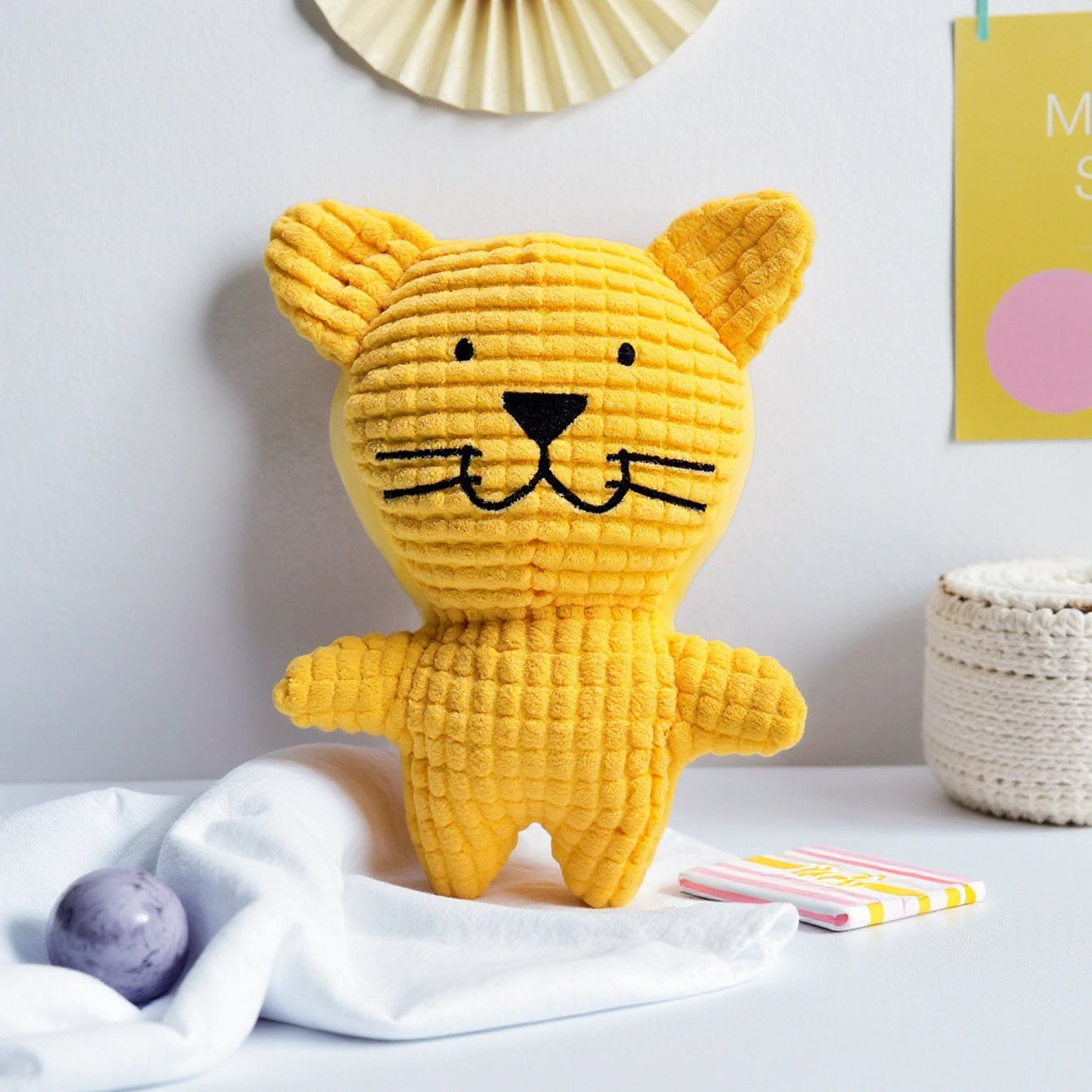 Yellow Cat Plush Toy with a cute face and textured fabric.
