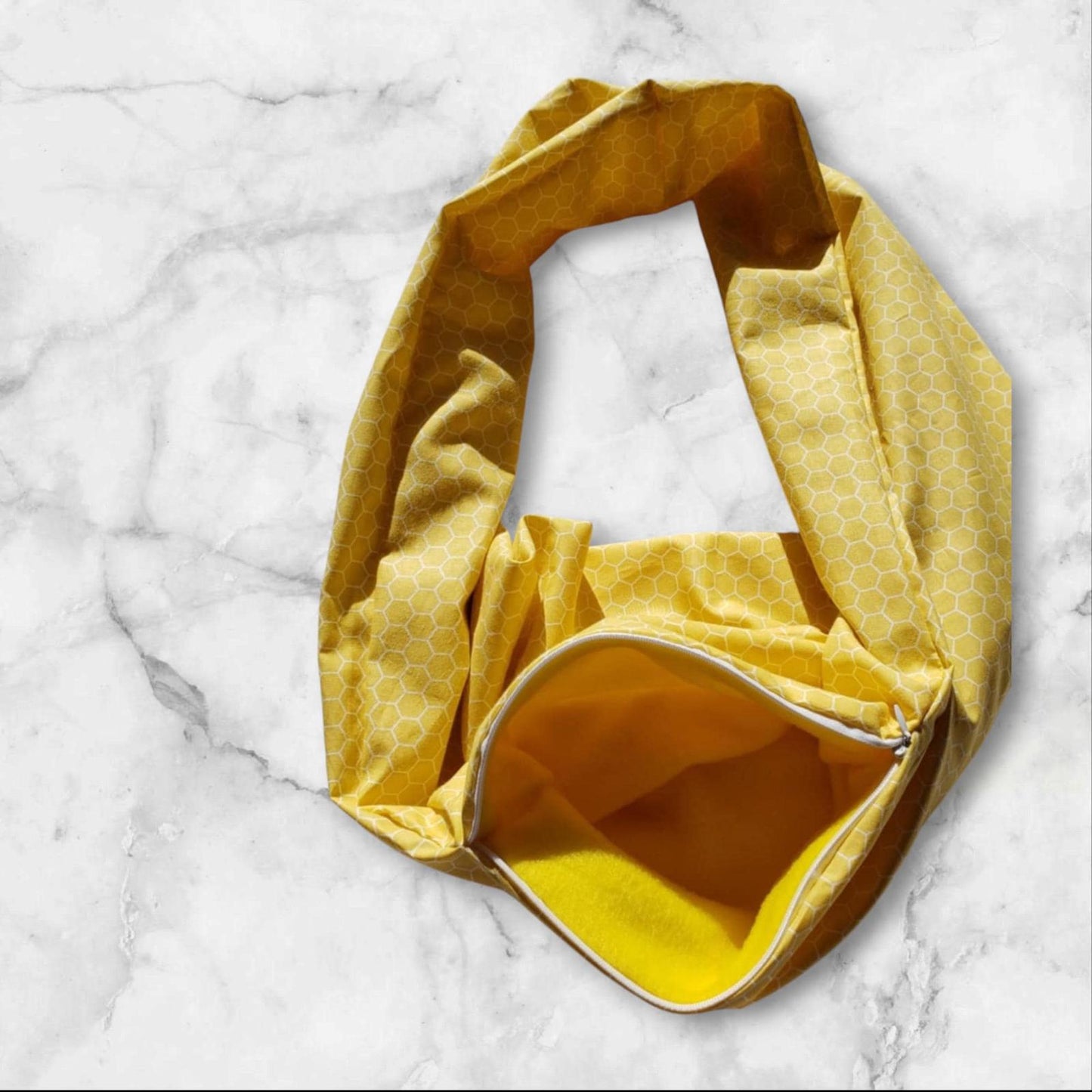Yellow patterned tote bag with a zipper pocket, perfect for everyday use.