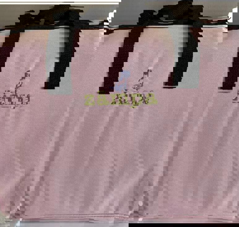 Zampa pink tote bag with black handles and embroidered logo.