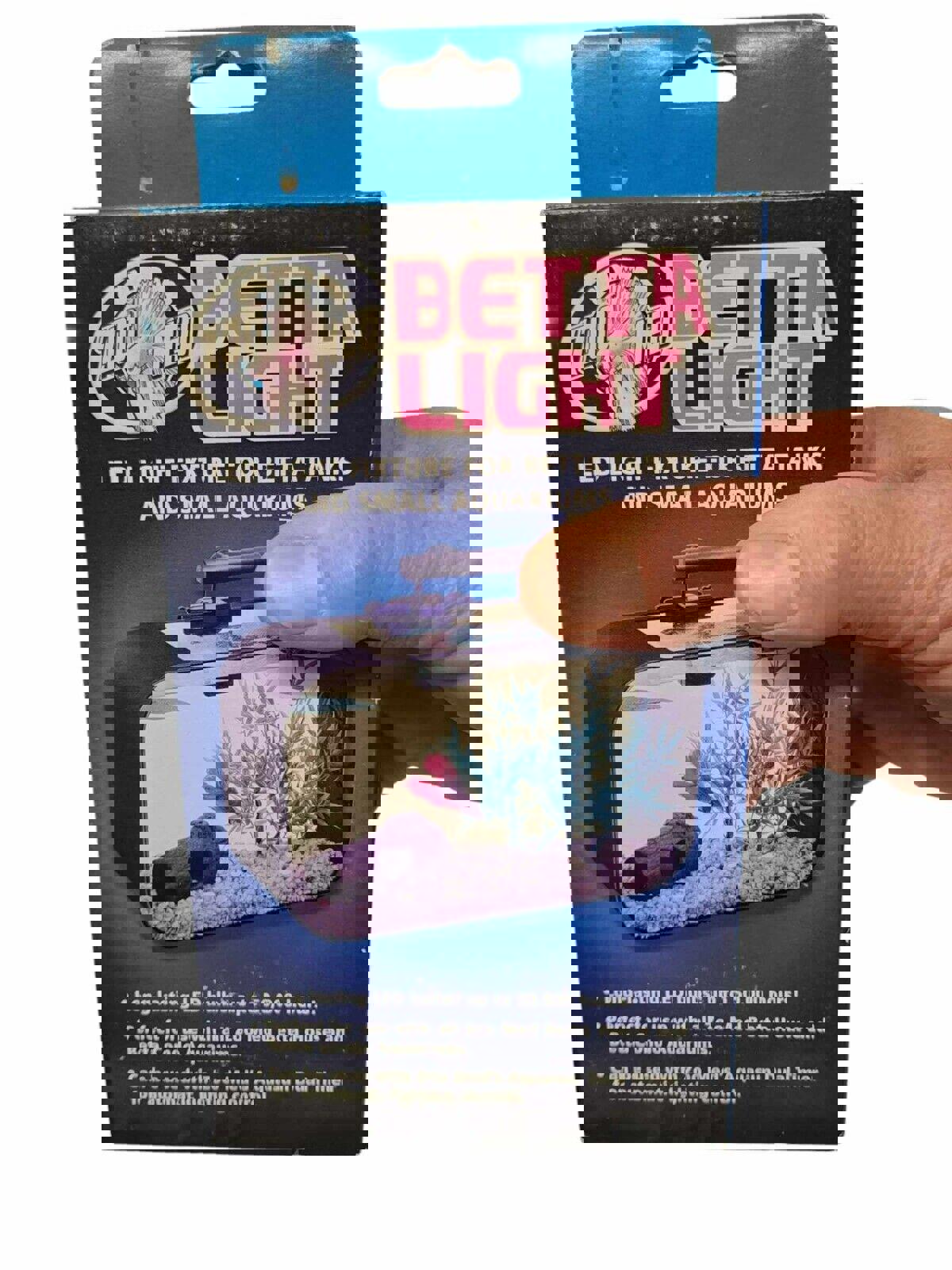 Zoo Med Betta Light LED fixture for betta tanks and small aquariums with a hand holding the box.